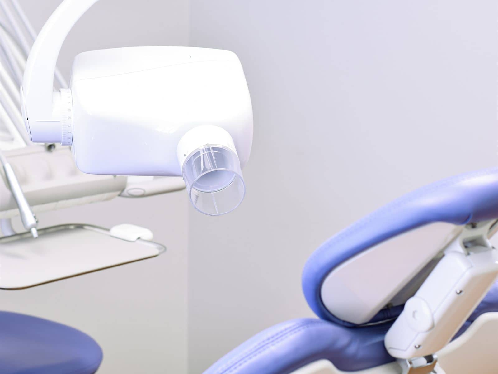 The chairside X-ray arm beside a patient chair